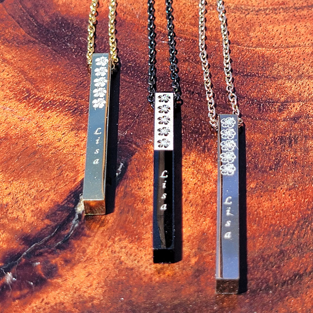 Stainless steel vertical bar pendant engraved with a hibiscus flower
