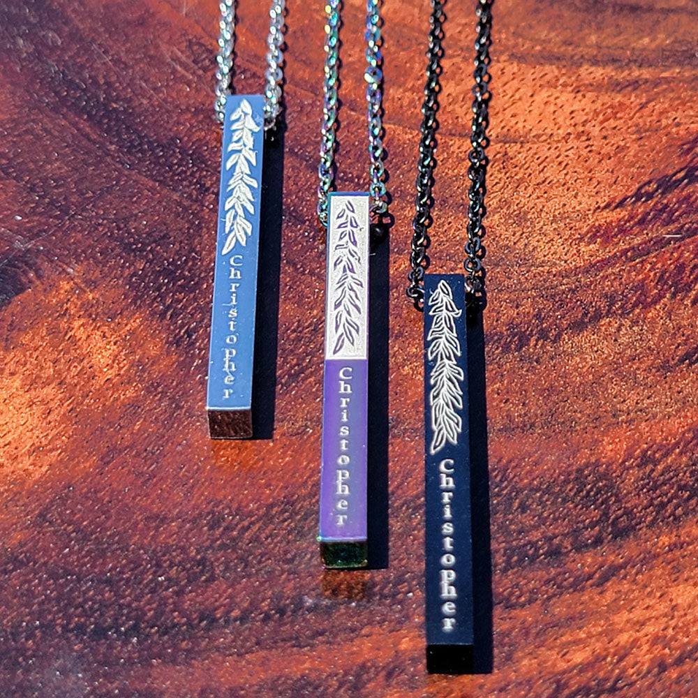 Vertical stainless steel bar pendant with maile leaf engravings and customizable center engraving