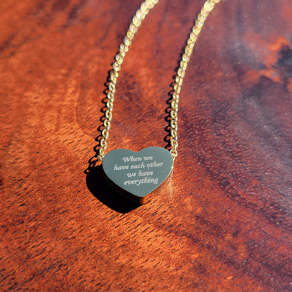 Heart pendant in stainless steel engraved with When We Have Each Other We Have Everything