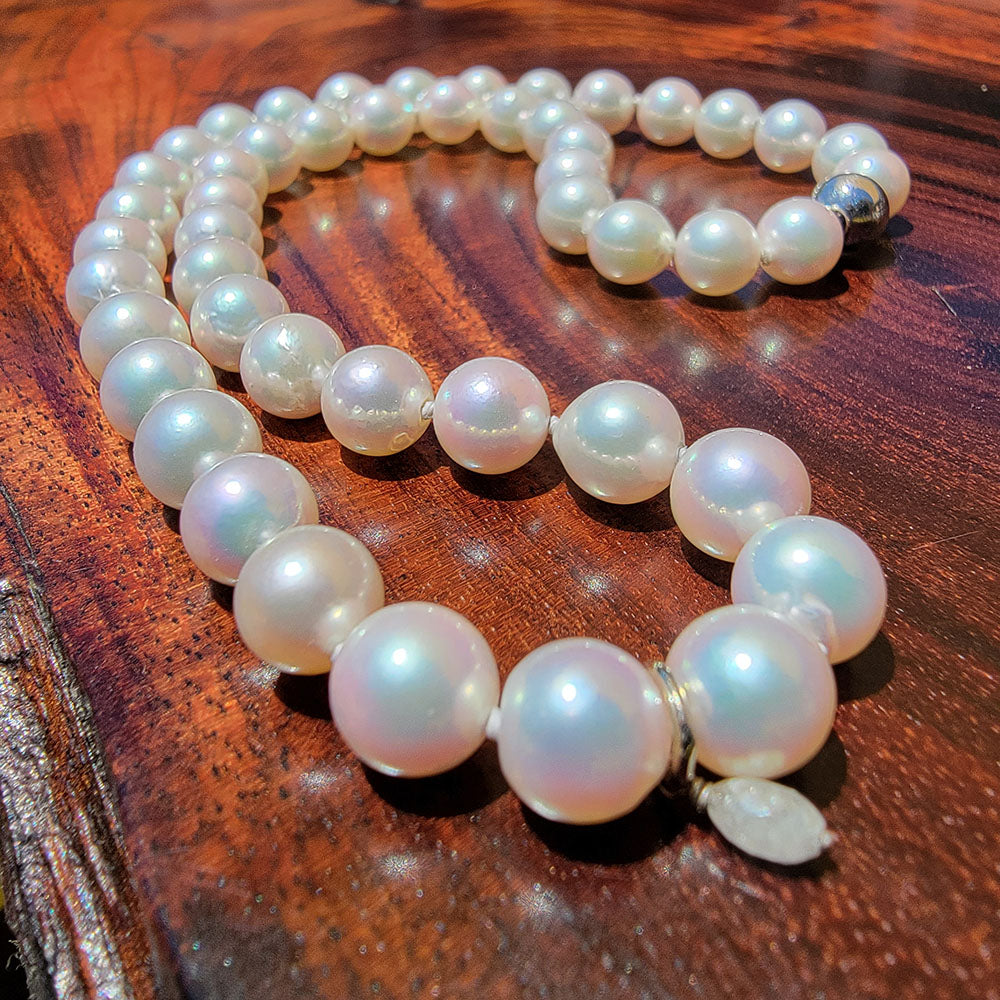 Japanese Akoya pearl necklace featuring 48 white near round 8–8.5mm pearls with a 0.25ct faceted diamond teardrop pendant and a 14K white gold clasp
